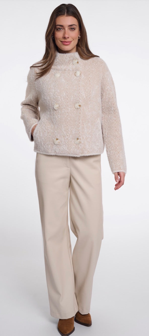 A woman modelling Rino & Pelle light beige textured cropped jacket with a high mock neck and double-breasted buttons, paired with matching beige wide-leg trousers, against a plain white studio background.