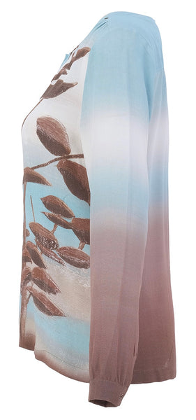 Dolcezza long-sleeve blouse with a vertical ombré colour block design in light blue, white, and dusty rose, featuring a brown leaf branch graphic printed on the front.