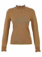 Dolcezza  taupe knit sweater with a ruffled mock neck and matching ruffled cuffs, accented with small white pearl-like studs, shown on a plain white background.