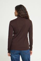 A woman viewed from the back wearing an Ichi dark brown Roll neck long-sleeve top and blue jeans, against a plain light gray studio background.