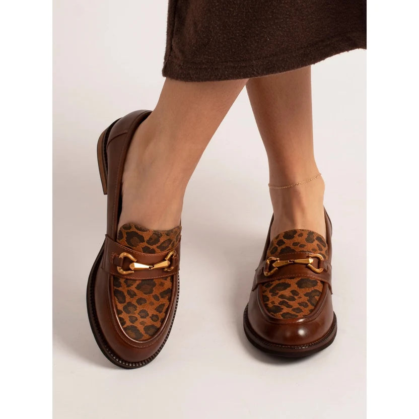 Lunar Women's Brown loafers with leopard print accents worn by a person on a white background