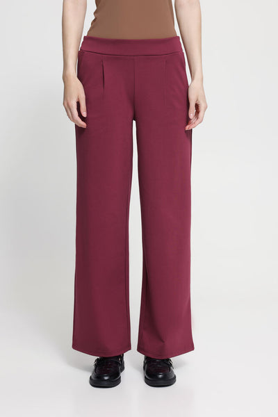 Ichi burgundy wide-leg pants worn by a person on a white background