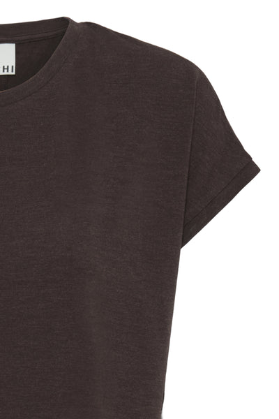 Close-up of a dark brown short-sleeve crewneck t-shirt, showing the fabric texture and a small white brand label at the inner collar.