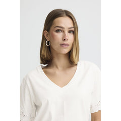 Women wearing cream v neckline Tshirt on a white background 