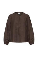 A dark brown long-sleeve blouse with a drawstring tie neckline and elasticized cuffs, shown flat against a white background. The brand name 'ICHI' is visible on the inner neck label.
