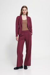 Woman wearing Ichi burgundy wide leg trousers with matching Jacket against a white background