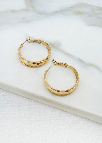 Envy Gold hoop earrings on a marble surface