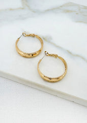 Envy Gold hoop earrings on a marble surface