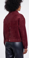 A person shown from the back wearing a Rino & Pellet burgundy cropped jacket with buttons and black leather pants against a plain light background.