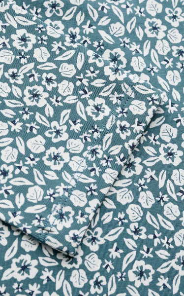 A close up of a fabric  with an allover floral print in white and blue. 