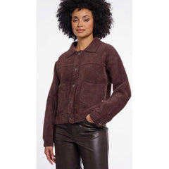 A woman wearing a Rino & Pelle dark brown textured button up jacket with front pockets, paired with dark brown faux-leather pants, against a plain white background.