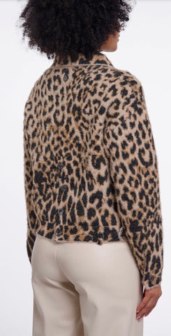 Close-up of a leopard print Rino Pelle faux fur garment with black buttons and a horizontal seam.