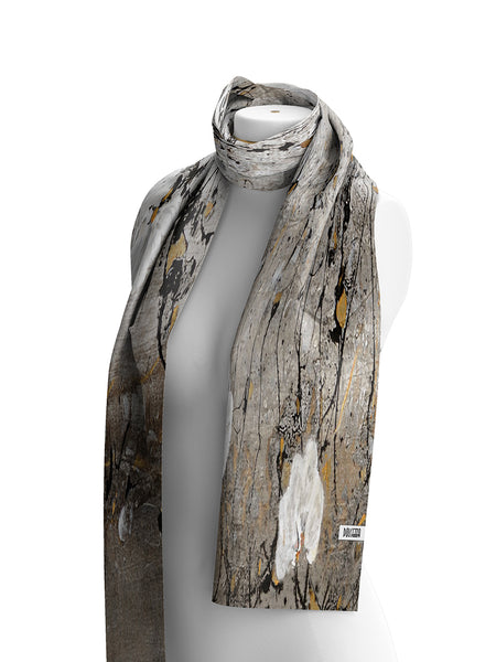 Dolcezza lightweight scarf with an abstract bark-like pattern in grey , beige, black, and gold, draped on a white mannequin torso against a white background.