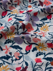 Floral fabric with colourful flowers on a white background.
