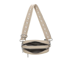 Beige crossbody bag with patterned strap on a white background