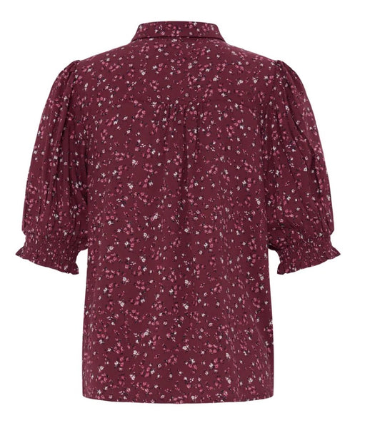 Ichi burgundy short-sleeve blouse with a white and light pink floral print, featuring puffed sleeves and a collar, shown against a plain white background.