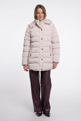 A woman modelling a Rino & Pelle light beige padded coat with a high collar and front buttons, paired with dark brown wide-leg trousers, against a plain white studio background.