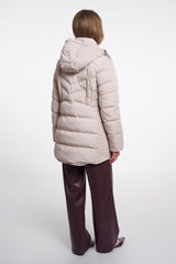 A woman shown from the back wearing a light beige padded coat and dark brown wide-leg trousers against a plain white studio background.