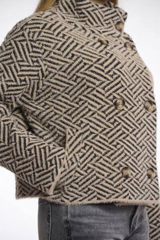 Back of Woman wearing a patterned rino pelle jacket on a white background