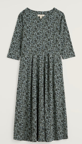Seasalt midi dress with a dark green and navy floral print, featuring a gathered waist and a round neckline, shown against a plain light background.