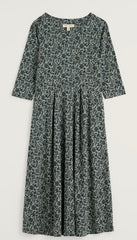 Seasalt midi dress with a dark green and navy floral print, featuring a gathered waist and a round neckline, shown against a plain light background.