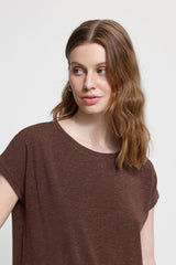 Woman wearing a brown t-shirt against a white background