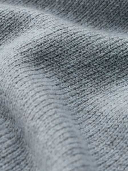 Close up of Seasalt light blue ribbed knit fabric texture with soft folds.