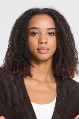 Close up of model wearing a white top and chocolate v neck brown cardigan.