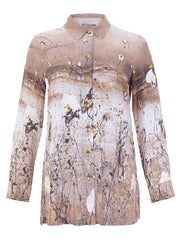 A long-sleeve Women's Dolcezza button-up shirt with a beige, brown, and white abstract paint-splatter print, featuring small gold-tone buttons down the front.