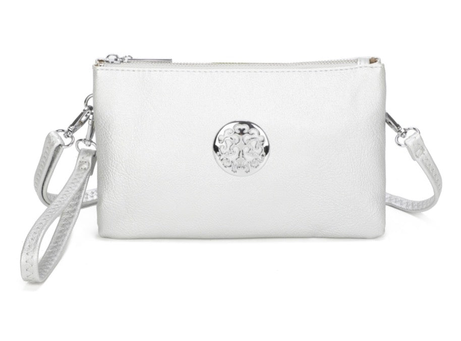 Wristlet purse crossbody mini bag in silver with wrist strap and long attachable strap included. Silver tree of life motif on front of bag with zipper fastening. Displayed on white background.