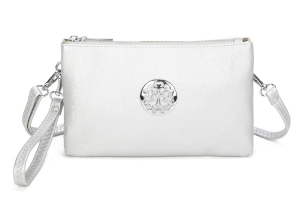 Wristlet purse crossbody mini bag in silver with wrist strap and long attachable strap included. Silver tree of life motif on front of bag with zipper fastening. Displayed on white background.