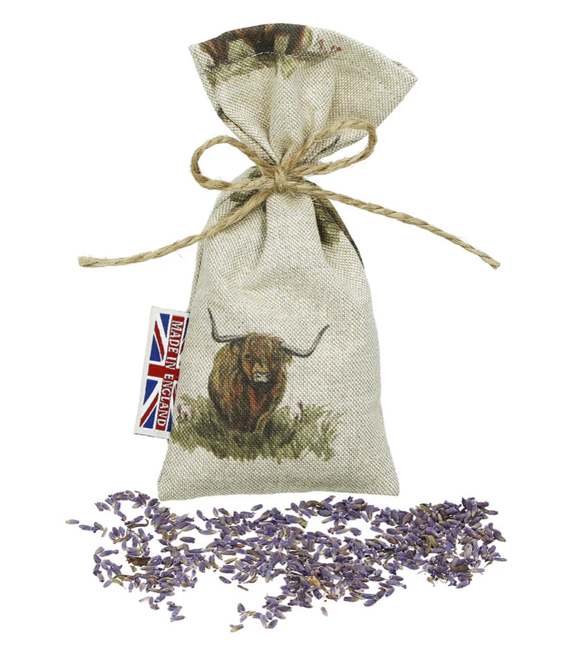 The Wheat Bag Company Lavender Herbal drawstring bag with a Scottish highland cow design and lavender flowers.