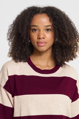 A person wearing an Ichi striped cream and burgundy top with a crew neckline.