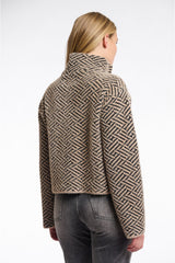 Back of Woman wearing a patterned rino pelle jacket on a white background