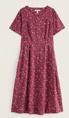 Seasalt short sleeve A-line dress with a dense pink, red, and white floral print, displayed flat against a light off-white background.