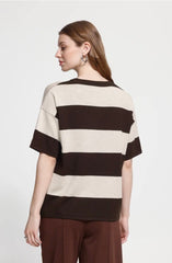 Back profile of woman wearing an Ichi brown and cream striped Ichi Top with brown trousers against a light grey background