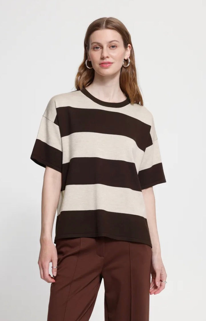 Woman wearing an Ichi brown and cream striped short sleeve, crew neck top with brown trousers on a light grey background.