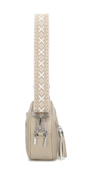Beige handbag with a patterned strap on a white background