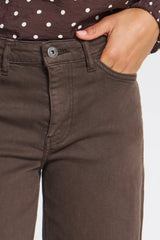 Close up of waistband Ichi jeans in coffee brown with person hand in pocket showing silver button fastening. 