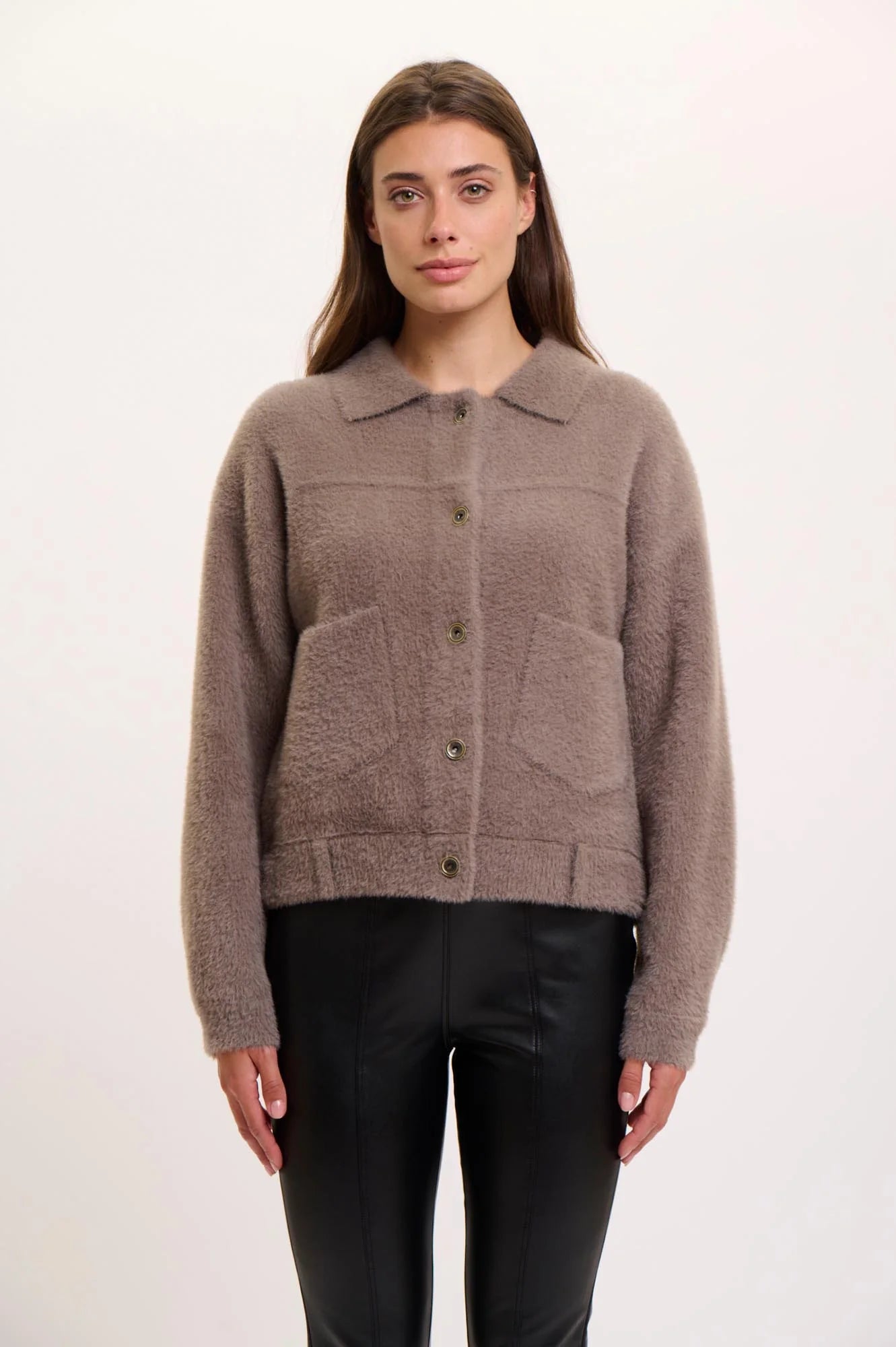 Woman wearing a  rino pelle bubbly jacket in taupe on a white background
