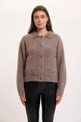 Woman wearing a  rino pelle bubbly jacket in taupe on a white background