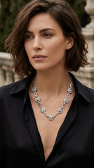 Woman wearing back blouse modelling Envy Jewellery silver coloured chunky necklace with diamanté detail. 