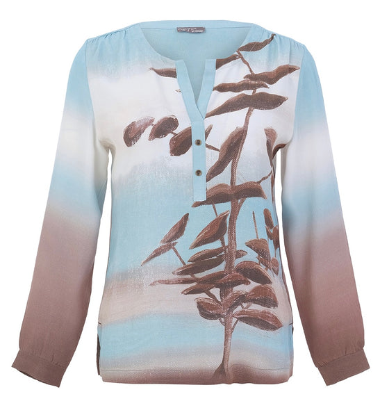 Dolcezza long-sleeve blouse featuring a gradient colour blocked design transitioning from light blue at the top to white in the middle and dusty rose at the bottom, with a brown botanical branch and leaf pattern printed across the front.