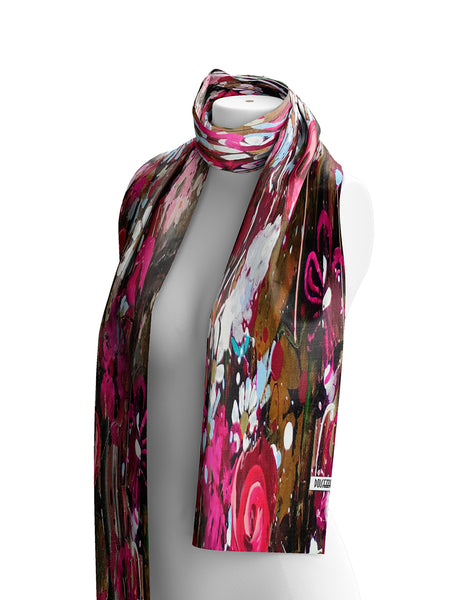 Dolcezza lightweight scarf with an abstract, painterly print in vibrant pink, brown, white, and black, draped on a white mannequin torso against a plain white background.