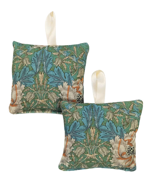 Two decorative pillows with floral pattern on a white background.