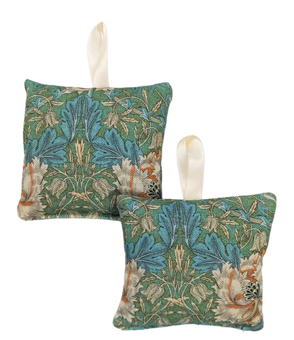 Two decorative pillows with floral pattern on a white background.