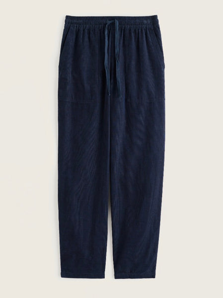 A pair of dark navy blue trousers with an elastic waistband and drawstring, displayed flat against a light beige background.