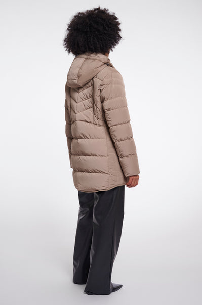 Woman wearing a Rino & Pelle padded beige-brown coat on a white background