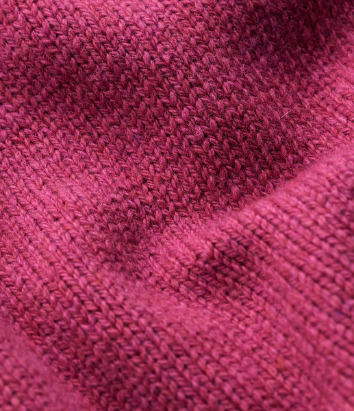 A close up of a Seasalt textured knit fabric in a dusty rose  pink colour, showing the detailed ribbed pattern and soft folds.