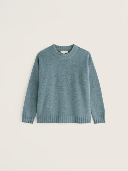 A dusty blue-green crewneck knit sweater with long sleeves and ribbed cuffs and hem, displayed flat against a light beige background.